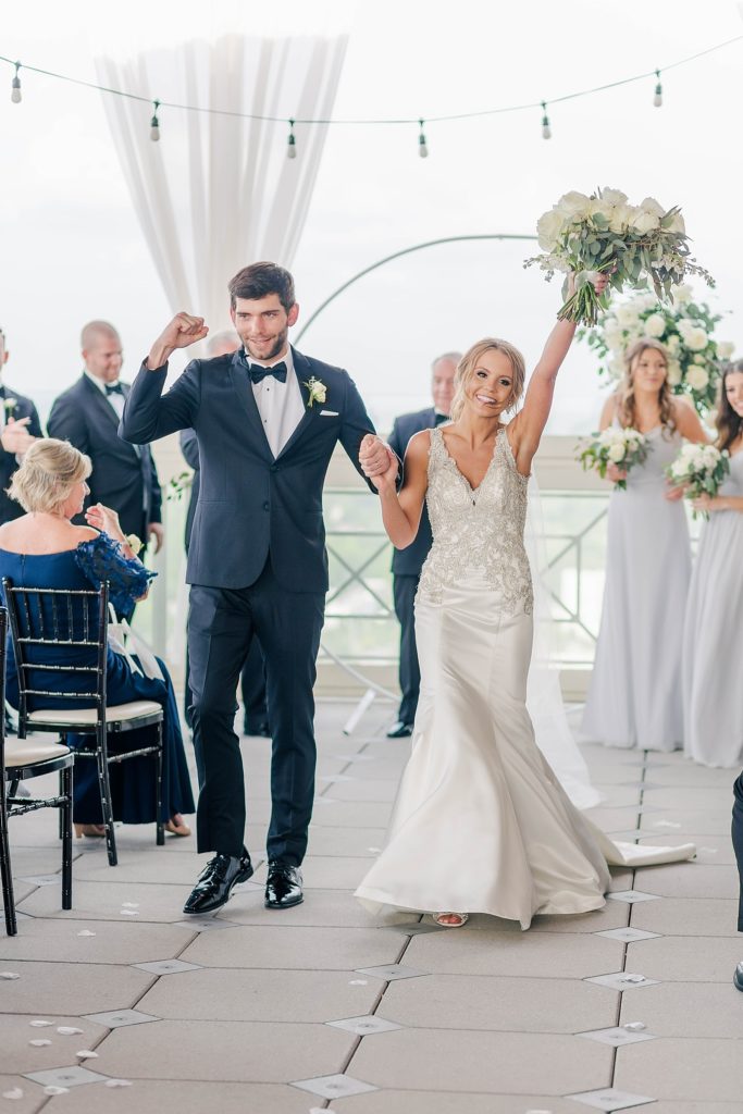 bride and groom cheer after getting married