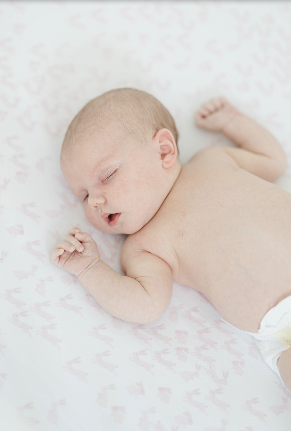 newborn baby laying in crib waiting for pictures in marietta georgia