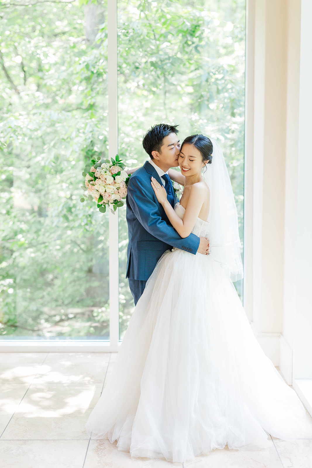 Happy newlyweds embracing inside the chapel of Ashton Gardens Wedding venue