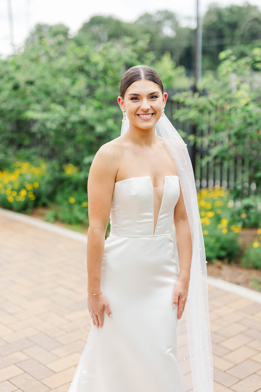 A happy bride smiles while standing in the garden at the Upstairs Atlanta Wedding venue