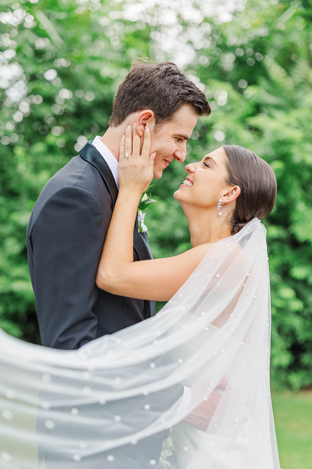 A happy bride leans in for a kiss in the lawn at the Upstairs Atlanta Wedding venue