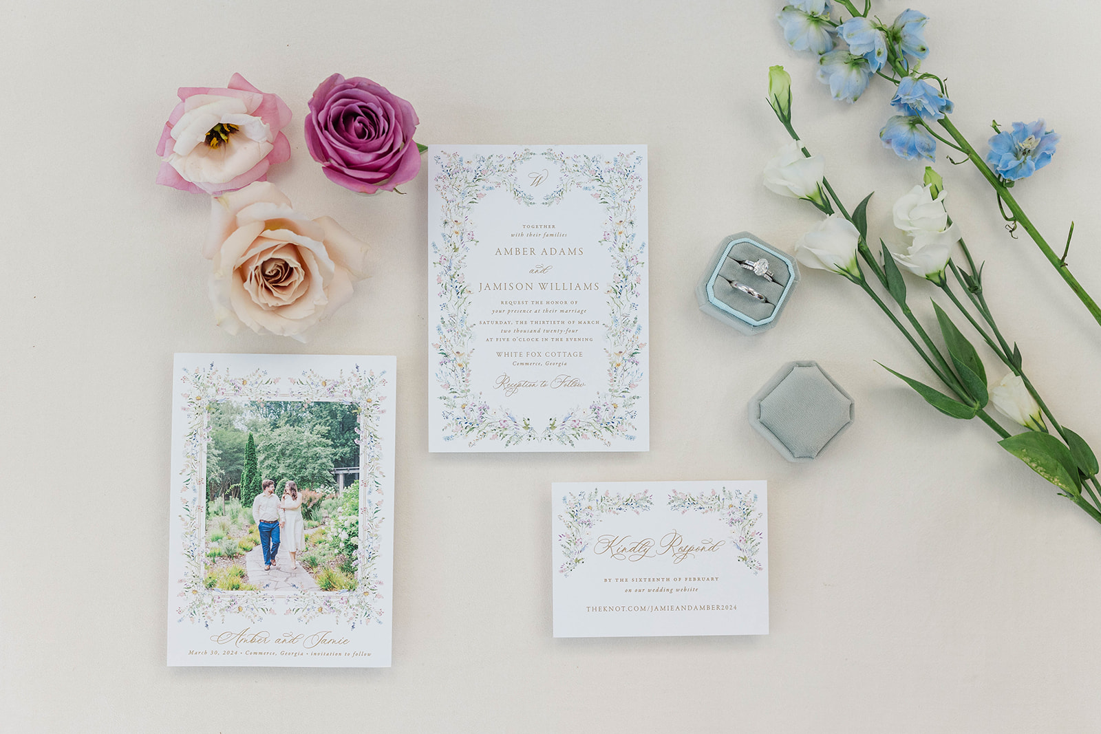 Details of a wedding invitation with rings and flowers