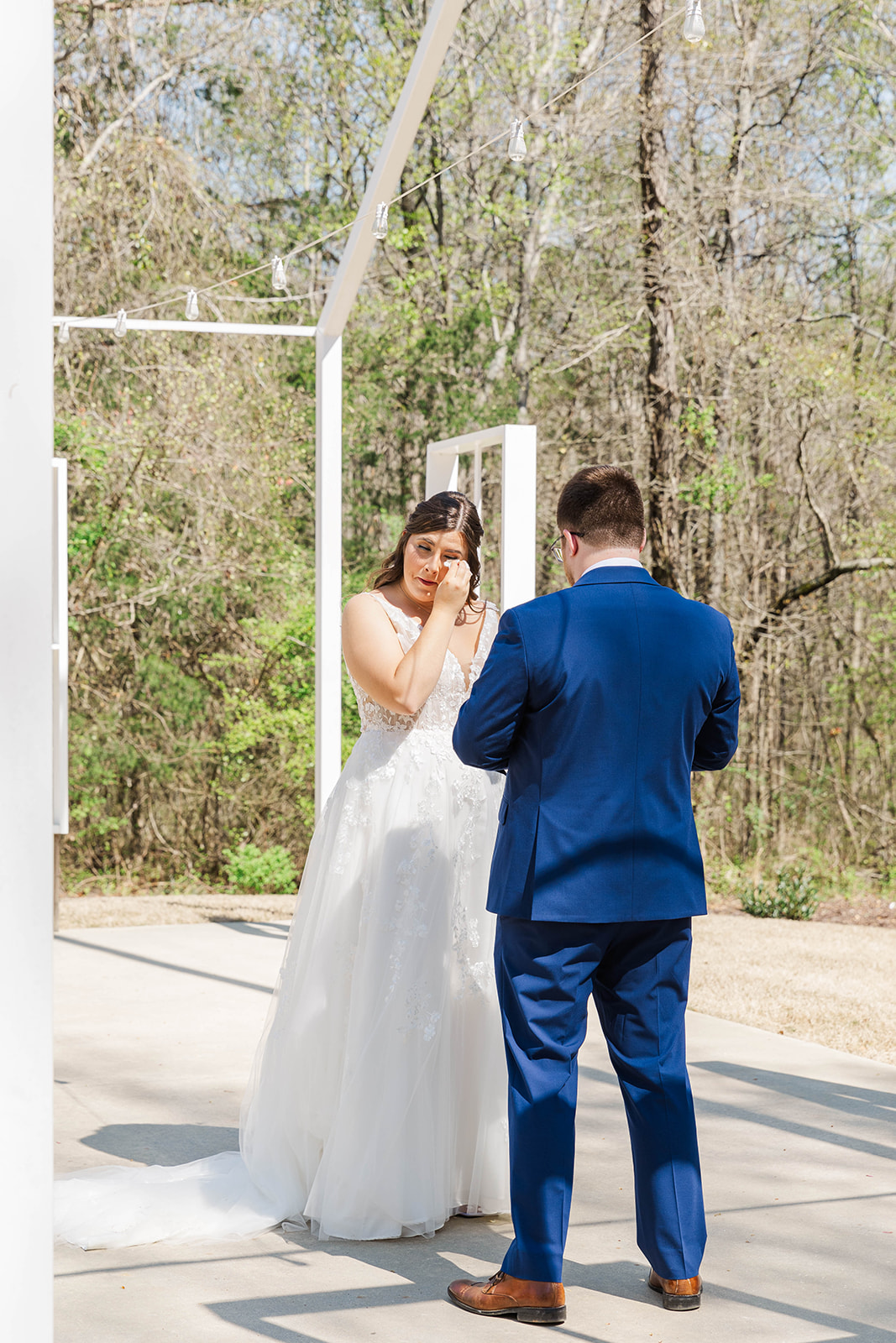 A bride cried during her first look on a patio