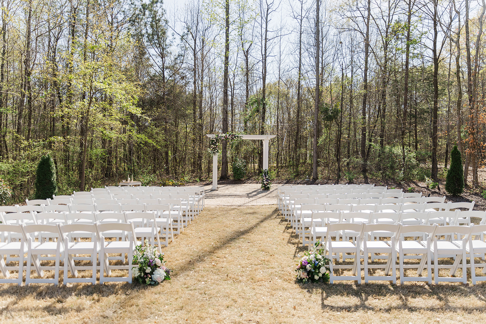 Details of the White Fox Cottage wedding pergola patio with white chairs set up