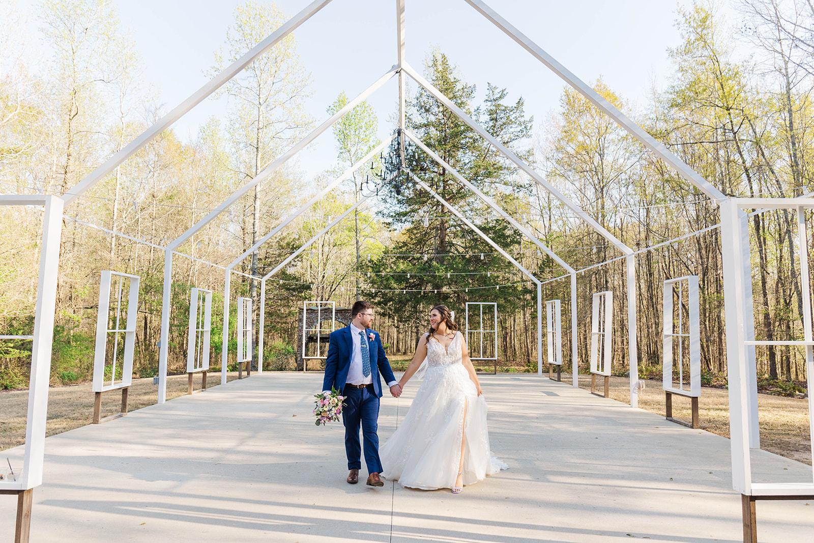 Newlyweds walk in the unique White Fox Cottage ceremony chapel frame location