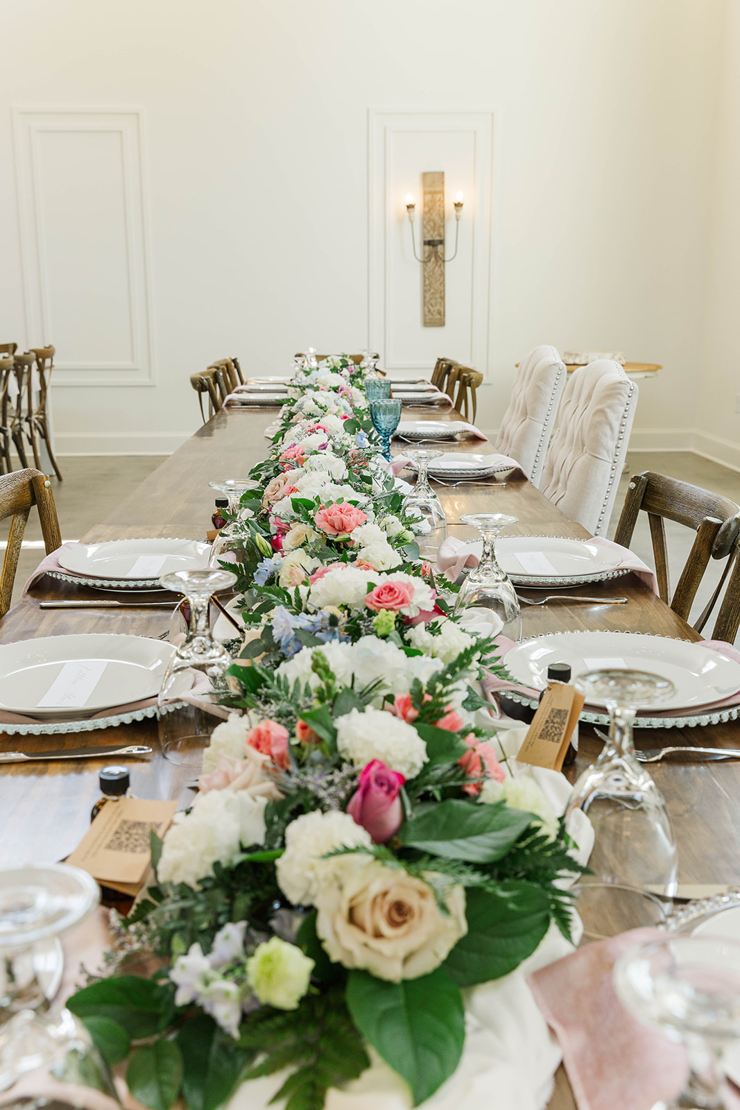 Details of a long reception table with full length floral centerpiece at White Fox Cottage