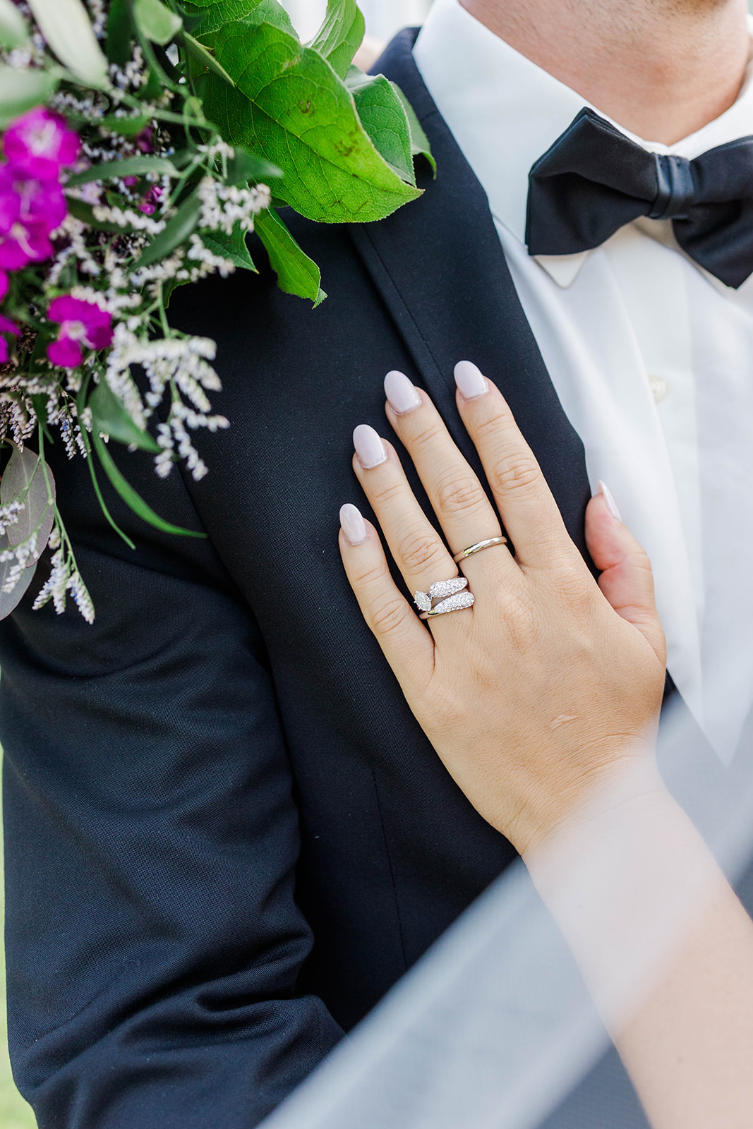 Details of a bride's unique rings on her hand on her groom's chest at one of the mansion wedding venues in Atlanta