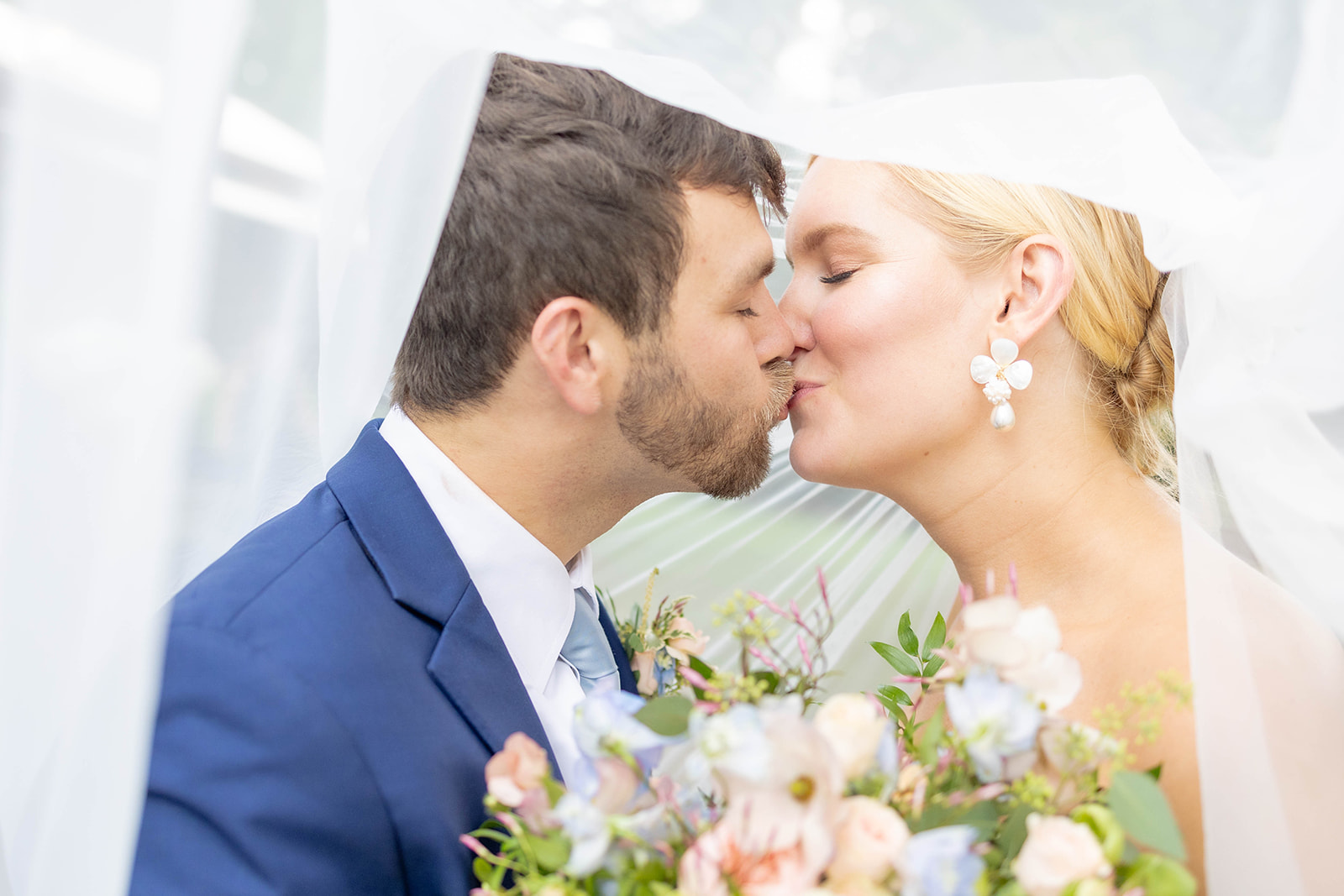 Newlyweds kiss under the veil at one of the mansion wedding venues in Atlanta