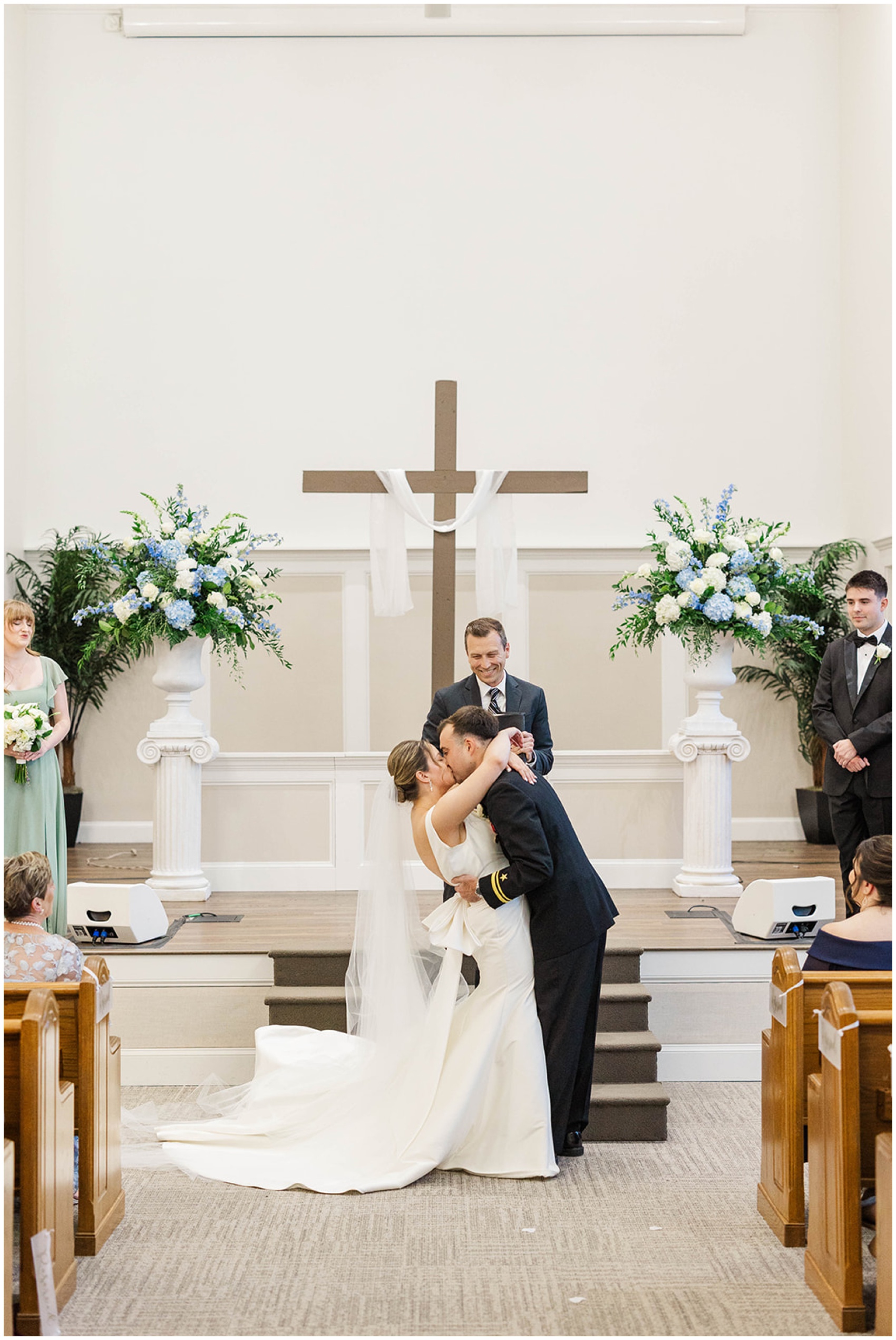 A bride and groom passionately kiss at the altar to end their Roswell Mill Club Wedding ceremony