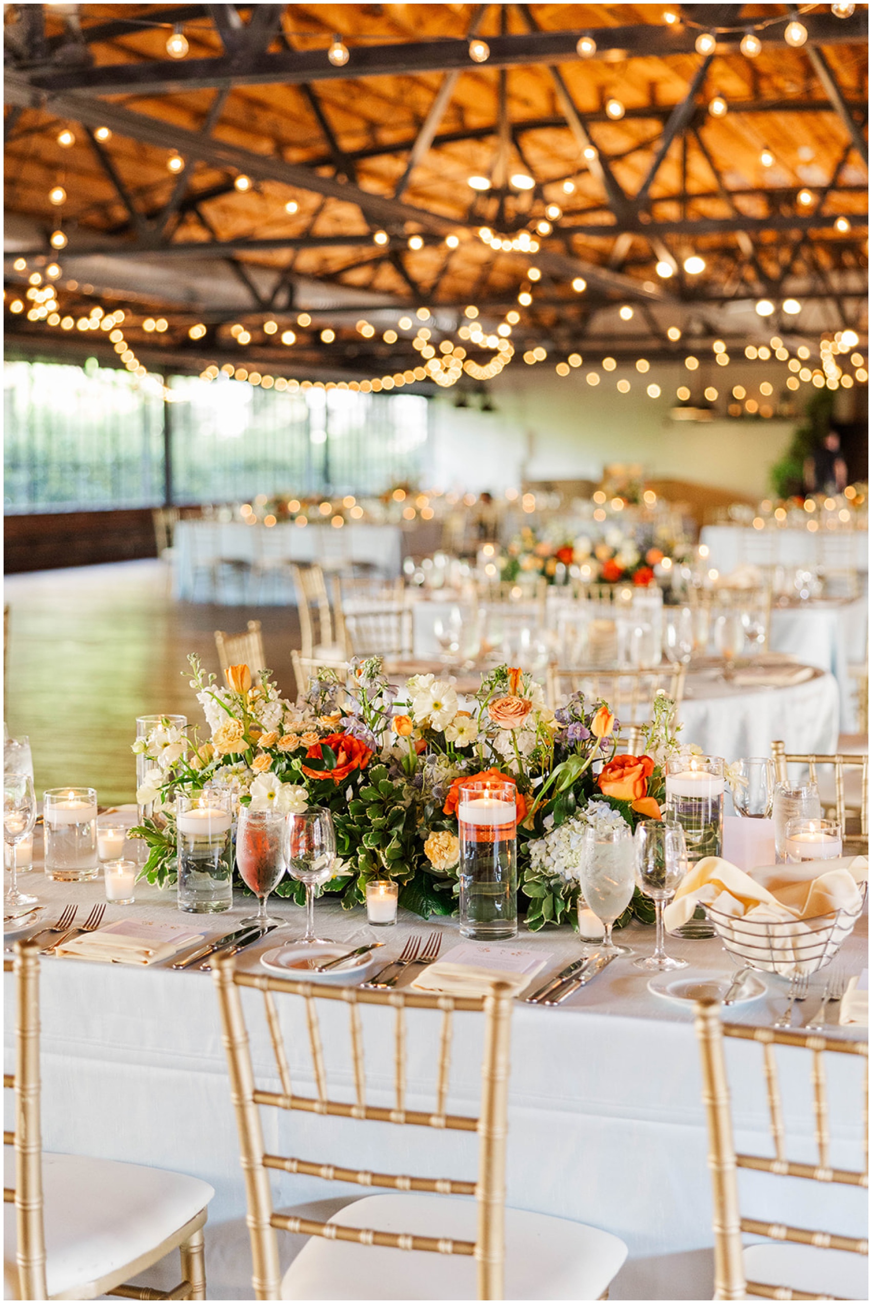 Details of a Summerour Studio wedding reception table complete with colorful flower centerpiece