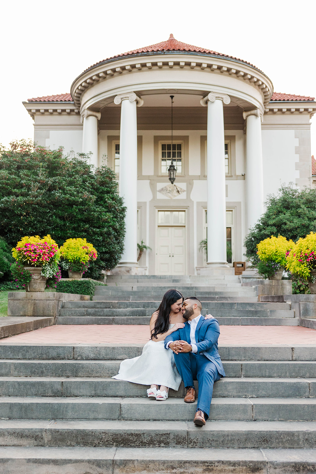 couple sitting on steps at Hills and Dales estate for engagement photos